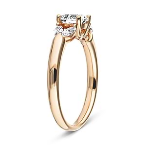 Unique marquise cut diamond accented engagement ring with round cut lab diamond center stone set in basket style 14k rose gold setting shown from side