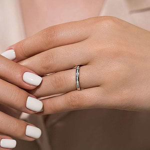  Channel set diamond accented wedding band 