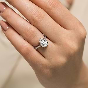 Beautiful diamond accented halo tear drop engagement ring with 1ct pear cut lab grown diamond in 14k white gold shown worn on hand