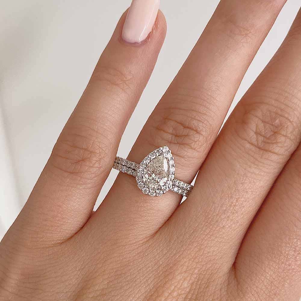Shown with a 1.2ct Pear cut Lab-Grown Diamond in recycled 14K white gold with matching wedding band