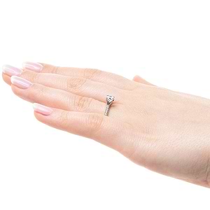 Diamond accented solitaire engagement ring with 4 prong set round cut lab grown diamond in 14k white gold worn on hand sideview