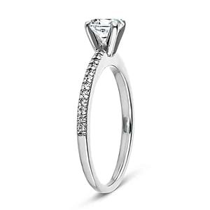 Diamond accented solitaire engagement ring with 4 prong set round cut lab grown diamond in 14k white gold shown from side