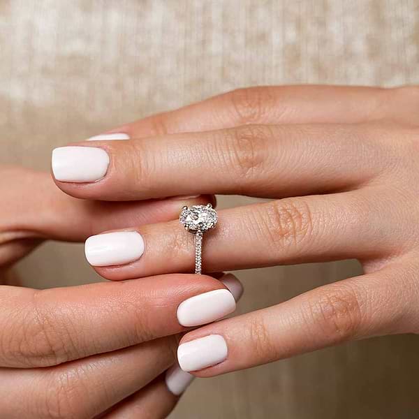 Shown with 1ct Oval Cut Lab Grown Diamond in 14k White Gold|Ethical diamond accented engagement ring with 1ct oval cut lab grown diamond in 14k white gold worn on hand