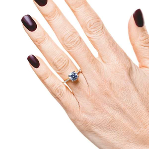 Diamond accented engagement ring with 1.5ct round cut lab grown diamond set in 6 prong 14k yellow gold setting worn on hand
