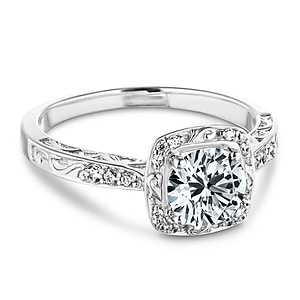 Antique style engagement ring with diamond accents and filigree detailing on the halo and band featuring 1ct round cut lab grown diamond in 14k white gold