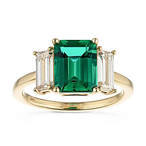 Stunning ethical three stone engagement ring with 2ct emerald cut lab created emerald center between baguette cut lab diamonds set in 14k yellow gold