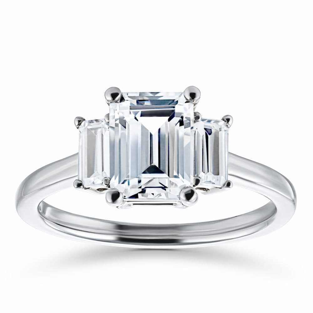 Shown with 1.75ct Emerald Cut Lab Grown Diamond in 14 White Gold|Ethical three stone engagement ring with 1.75ct emerald cut lab grown diamond center stone and two baguette cut diamond side stones in 14k white gold