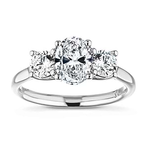 Beautiful three stone engagement ring with 1ct oval cut lab grown diamond and two 0.5ct round cut lab diamond side stones in 14k white gold