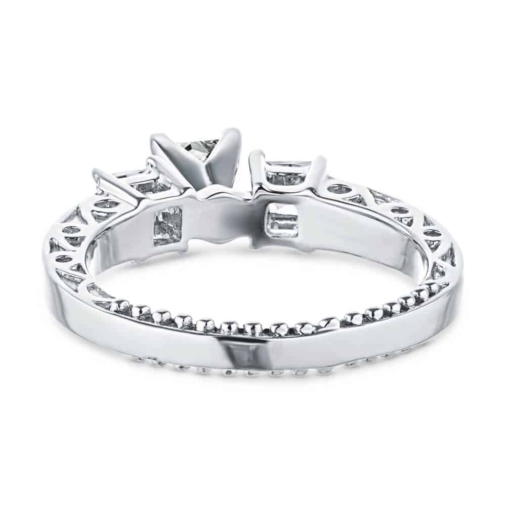 Shown with three Princess cut Lab-Grown Diamonds side stones with scroll detailing and accenting diamonds on the band in recycled 14K white gold 