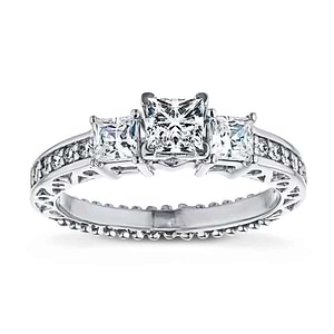 Vintage style three stone engagement ring with princess cut lab grown diamonds and filigree detailing in 14k white gold