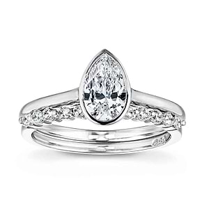  stackable wedding set Shown with a bezel set 1.0ct Pear cut Lab-Grown Diamond in recycled 14K white gold with the matching diamond accented band