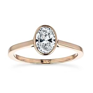  stackable engagement ring Shown with a bezel set 1.0ct Oval cut Lab-Grown Diamond in recycled 14K rose gold
