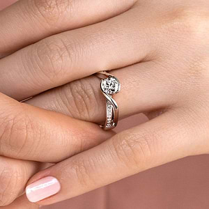 Ethical modern two tone engagement ring with diamond accented split shank and half bezel set 1ct round cut lab grown diamond in 14k white gold worn on hand