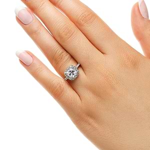 Diamond accented halo engagement ring with 1ct cushion cut lab grown diamond in 14k white gold worn on hand