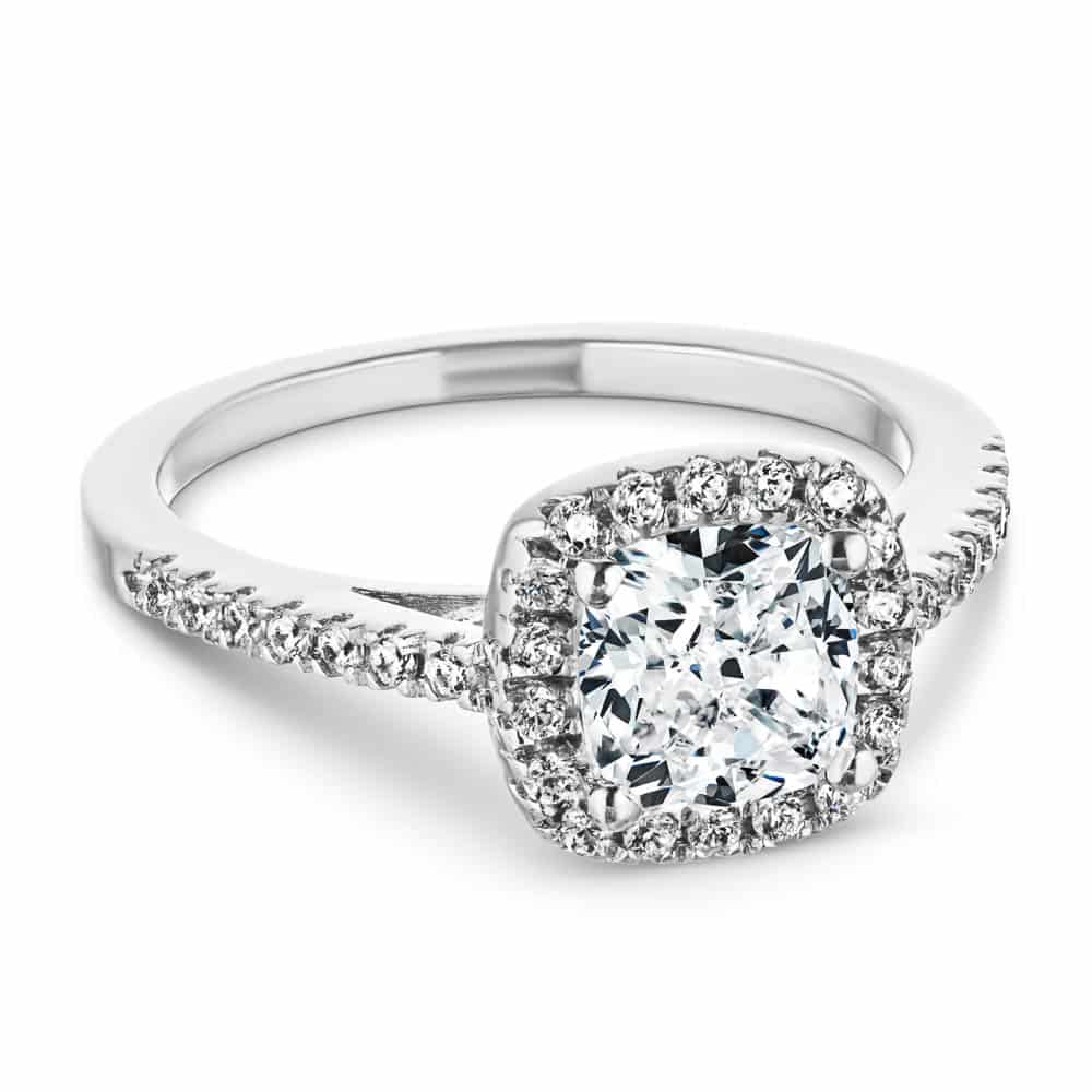 Shown with a 1.0ct Cushion cut Lab-Grown Diamond with a diamond accented halo and diamonds accenting the band in recycled 14K white gold with matching band 
