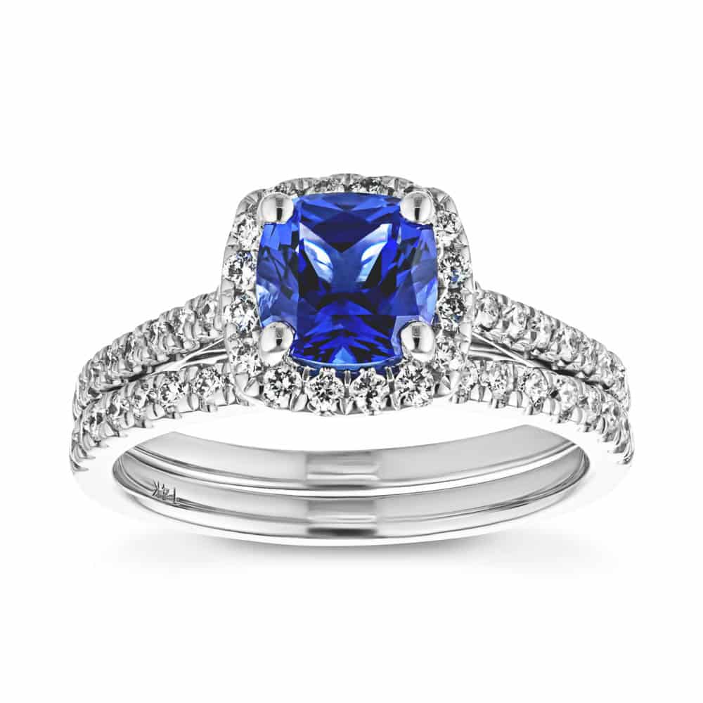 Shown with a 1.0ct Cushion cut Blue Sapphire Lab-Created Gemstone with a diamond accented halo and diamonds accenting the band in recycled 14K white gold with matching band, purchase the set for a discount 