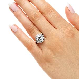 Flower halo engagement ring with diamond accented split shank holding a 1ct oval cut lab grown diamond in 14k white gold worn on hand