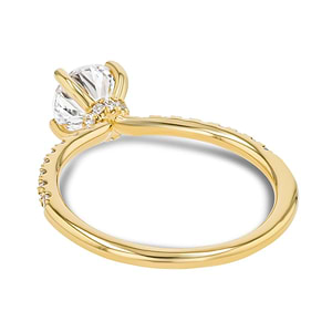 diamond accented engagement ring with a pinched hidden halo set with a 1 carat round cut lab grown diamond in 14k yellow gold metal