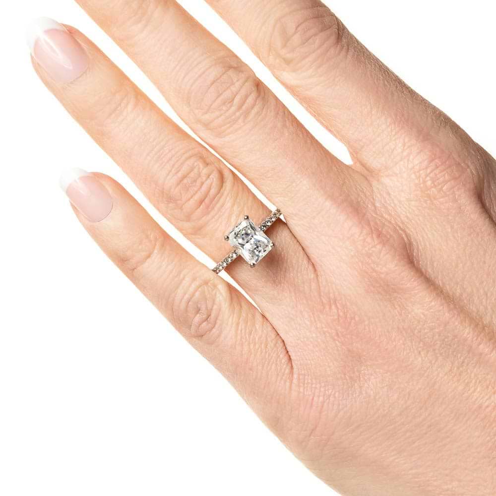 Shown with 1ct Round Cut Lab Grown Diamond in 14k White Gold|Stunning stackable diamond accented solitaire engagement ring with 1ct round cut lab grown diamond in 14k white gold held in hand