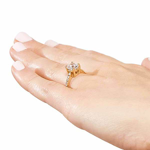 Diamond accented solitaire engagement ring with 1ct round cut lab grown diamond in 14k yellow gold worn on hand sideview