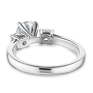 Three stone engagement ring with prong and basket set round lab diamonds in 14k white gold shown from back