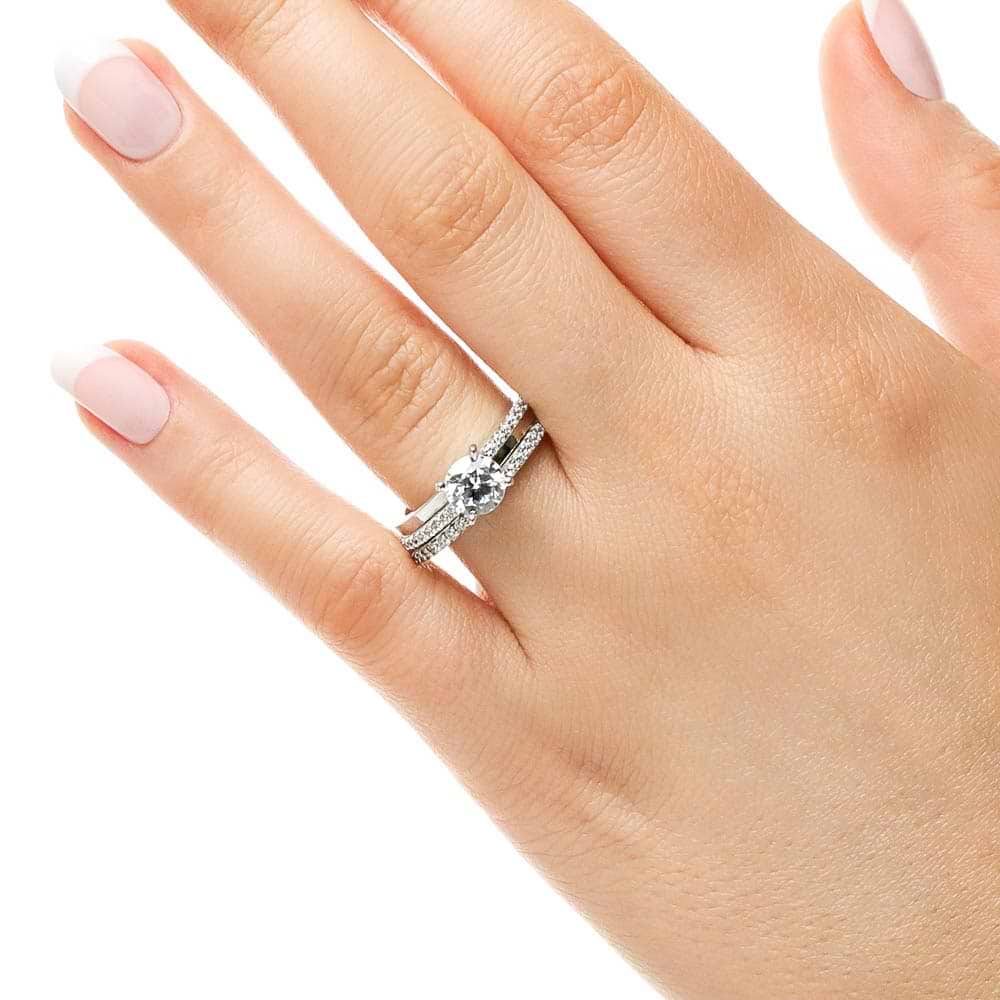 Shown with a 1.0ct Round cut Lab-Grown Diamond with accenting diamonds on the band in recycled 14K white gold with matching band, can be purchased together at a discounted price 