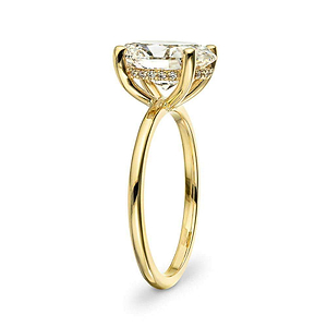 Hidden halo engagement ring with 4 prong set 3ct oval cut lab grown diamond in a thin 14k yellow gold band shown from side