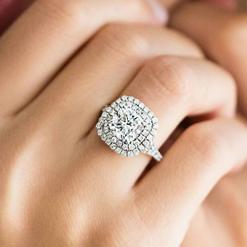 Shown with 1ct Cushion Cut Lab Grown Diamond in 14k White Gold|Luxurious double halo split shank engagement ring with diamond accents surrounding a 1ct cushion cut lab grown diamond in 14k white gold