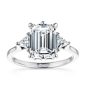 Gorgeous conflict free three stone engagement ring with 2ct emerald cut lab grown diamond center stone with triangle side stones set in 14k white gold band