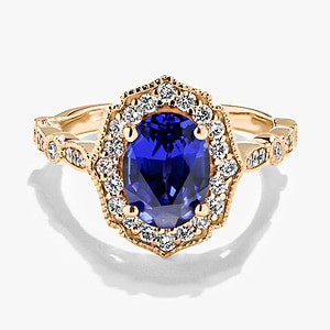 diamond accented vintage stackable ring with an oval cut lab created blue sapphire gemstone in 14k yellow gold