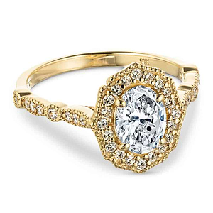 Romantic vintage style diamond accented halo engagement ring with a 1ct oval cut lab grown diamond set in filigree and milgrain detailed 14k yellow gold band