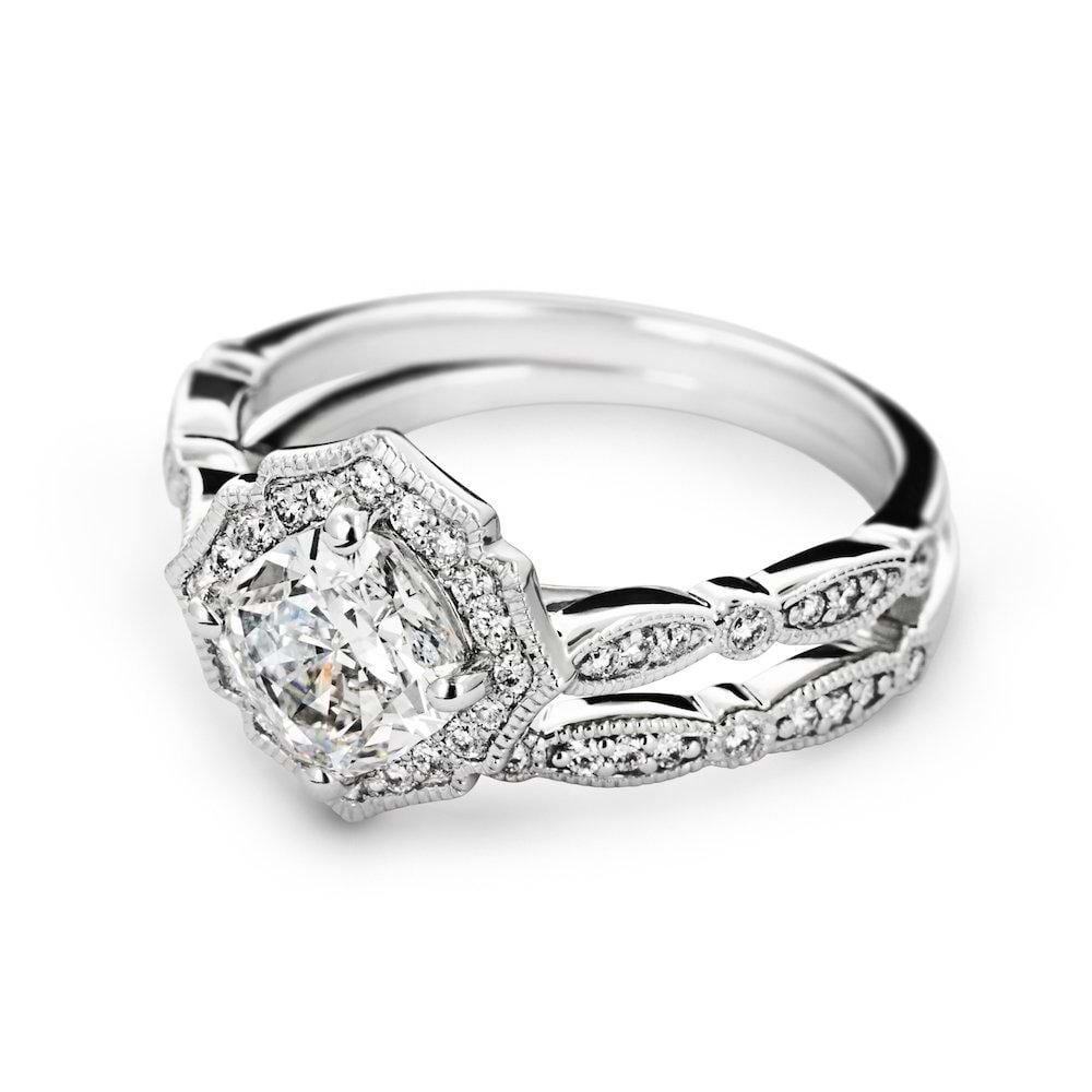 Shown with a 1.0ct Round cut Lab-Grown Diamond with a diamond accented halo and filigree detailing in recycled 14K white gold with matching wedding band, can be purchased together at a discounted price
