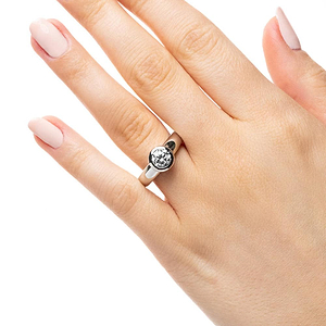 Modern bezel solitaire engagement ring with 1ct round cut lab grown diamond in 14k white gold setting worn on hand