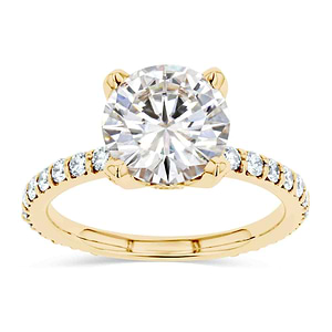 diamond accented vintage style engagement ring with accenting lab grown diamonds and a moissanite center stone with a peeka boo diamond in 14k yellow gold