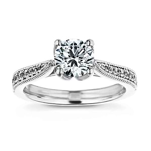 Unique vintage style milgrain and filigree detailed diamond accented engagement ring with a floral head holding a 1ct round cut lab grown diamond in 14k white gold band