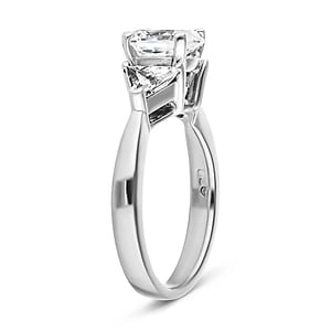 Three stone engagement ring with 1ct oval cut lab grown diamond and two 0.50 triangle cut diamond side stones in 14k white gold band shown from side