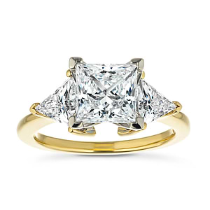 Beautiful ethical three stone engagement ring with 1.5ct princess cut lab grown diamond and two 0.50 triangle cut diamond side stones in 14k yellow gold band