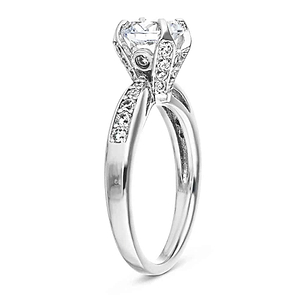 Channel set diamond accented engagement ring with 1ct round cut lab grown diamond and peek-a-boo diamonds in 14k white gold shown from side