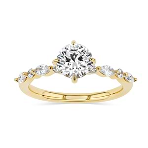 summer engagement ring with diamond accenting stones and a round cut center stone set in 14k yellow gold metal