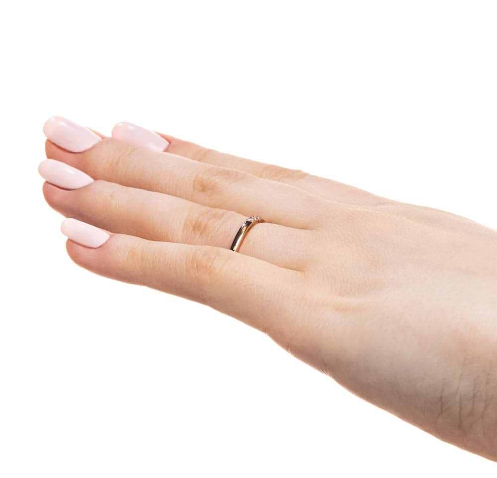 Three Lab-Grown Diamonds set in a simple band in recycled 10K rose gold 
