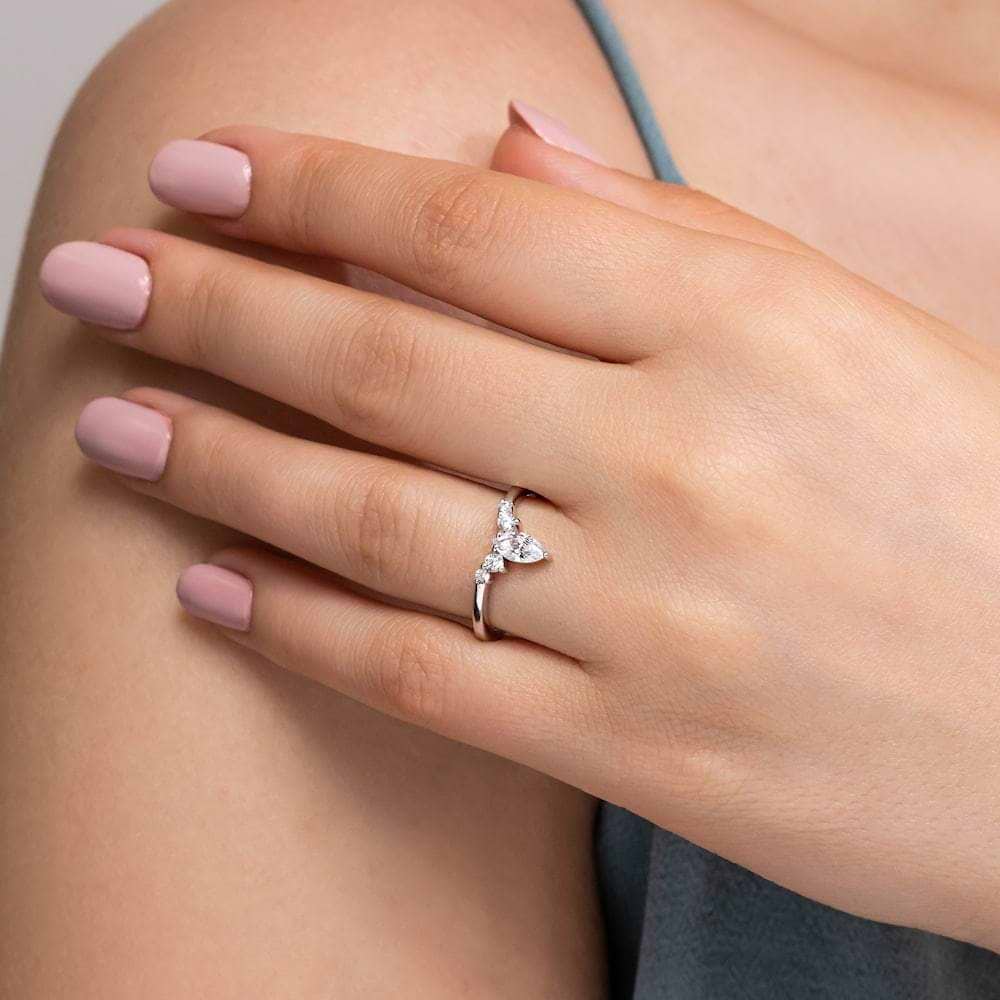 Shown here with a center 0.33ct marquis lab-grown diamond in recycled 14K white gold, with recycled earth-mined diamonds on either side.  | Lab-grown diamond and recycled diamond white gold traditional engagement ring.