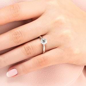 Classic solitaire engagement ring with 1ct round cut lab grown diamond in cathedral style 14k white gold band shown worn on hand