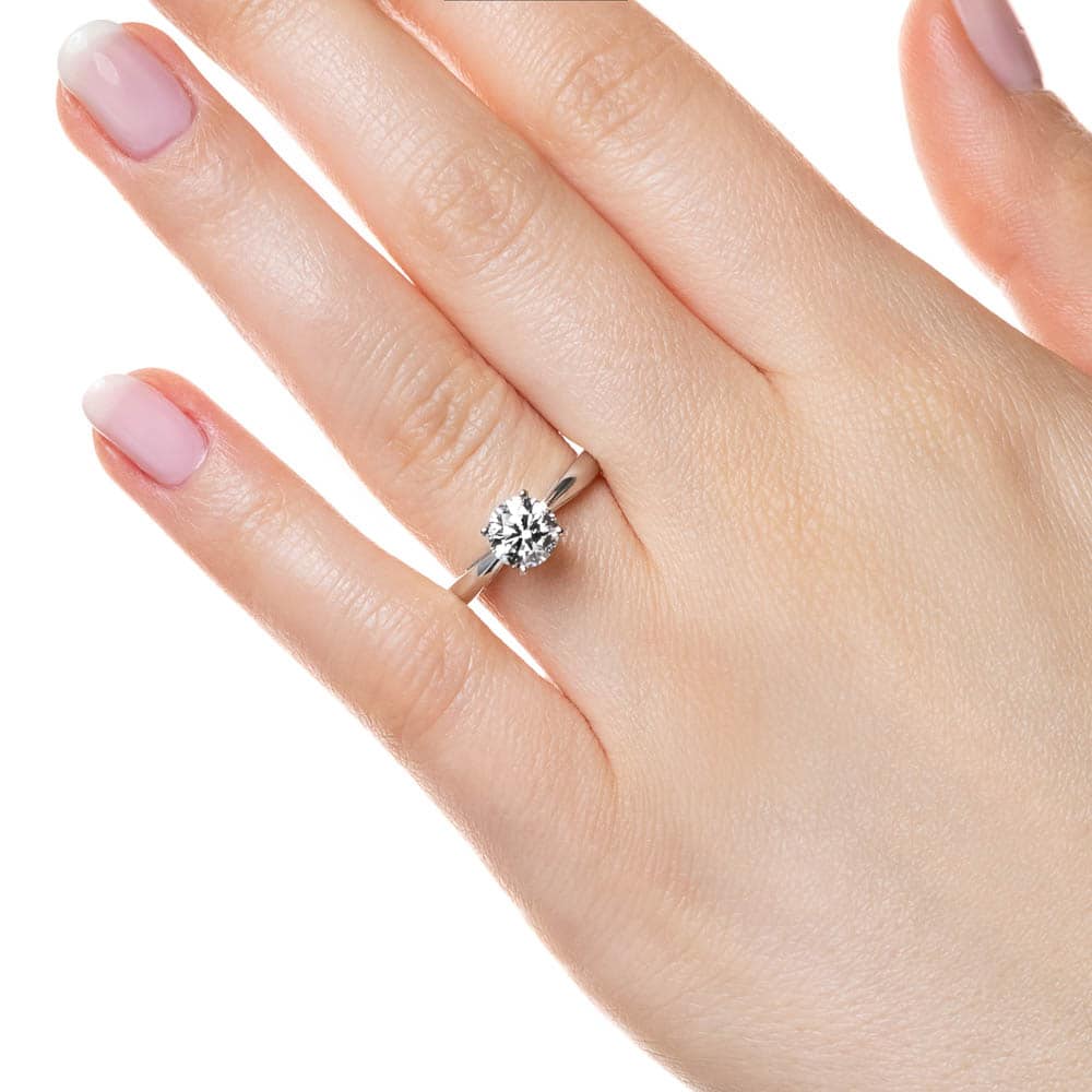 Shown with a 1ct Round Cut Lab Grown Diamond in 14k White Gold|Classic solitaire engagement ring with 1ct round cut lab grown diamond in cathedral style 14k white gold band shown worn on hand