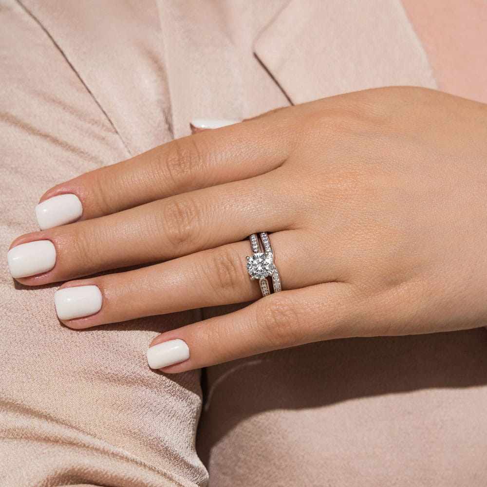 Unity Wedding Ring Set comes with your choice of round cut center stone accented with recycled diamonds channel set on engagement ring and wedding band&#39;s tapered shanks 