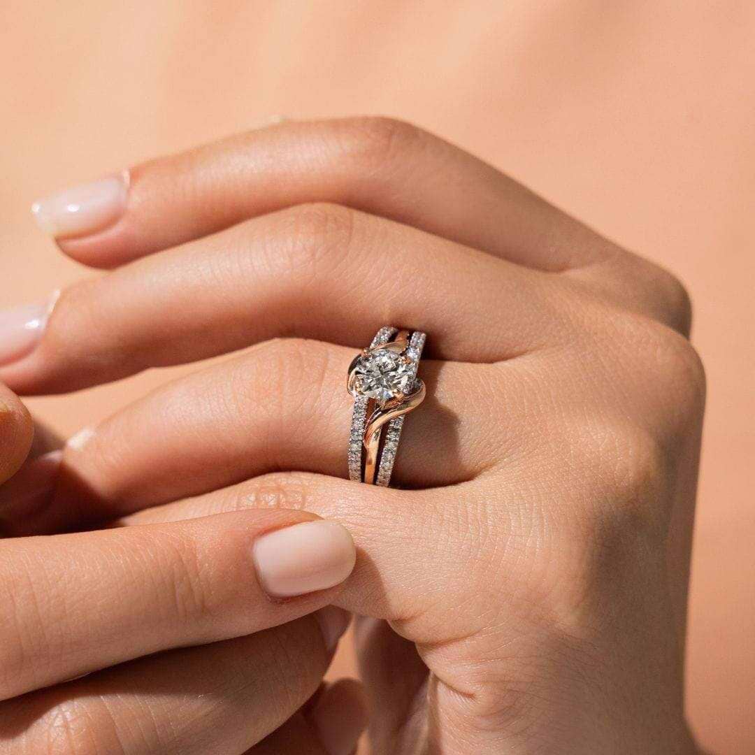 Vine Engagement ring shown with a round cut 1.0ct Lab-Grown Diamond center stone and a recycled 14K white  and rose gold band accented with recycled diamonds 