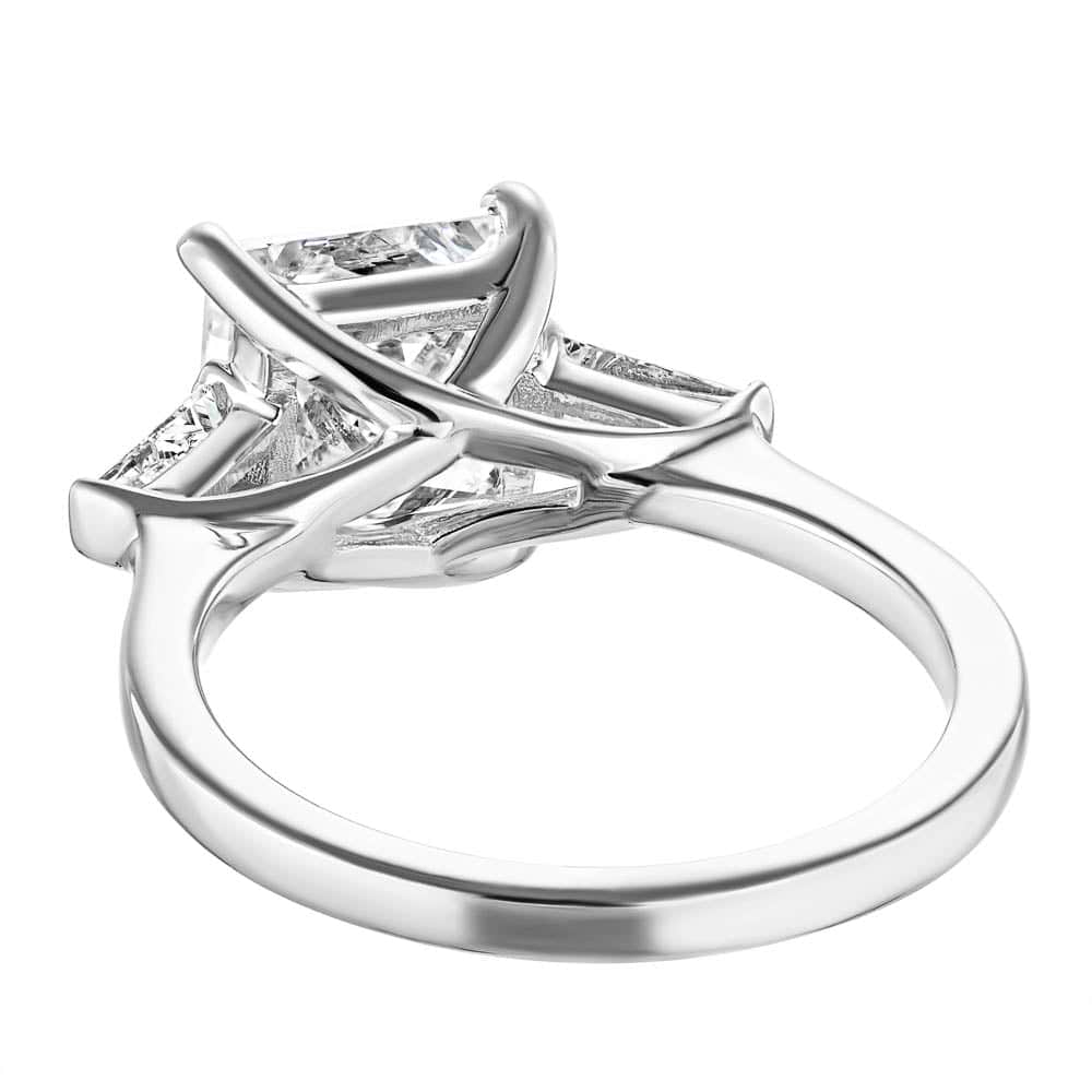 Shown with 2.5ct Princess Cut Lab Grown Diamond set in 14k White Gold|Beautiful three stone engagement ring with trellis set 2.5ct princess cut lab grown diamond amid baguette side stones in 14k white gold shown shown from back