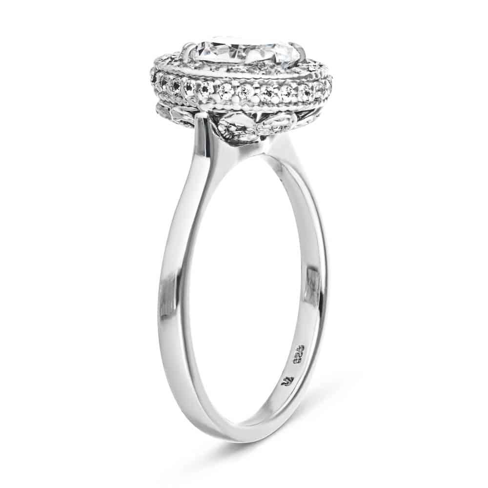 Shown with 1ct Oval Cut Lab Grown Diamond in 14k White Gold|Antique style diamond accented filigree halo engagement ring with 1ct oval cut lab created diamond in 14k white gold shown from side