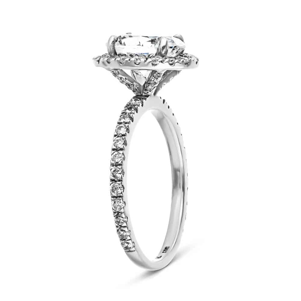 Shown with 1ct Oval Cut Lab Grown Diamond in Platinum|Dream diamond halo engagement ring with diamond accents and a 1ct oval cut lab grown diamond in platinum shown from side