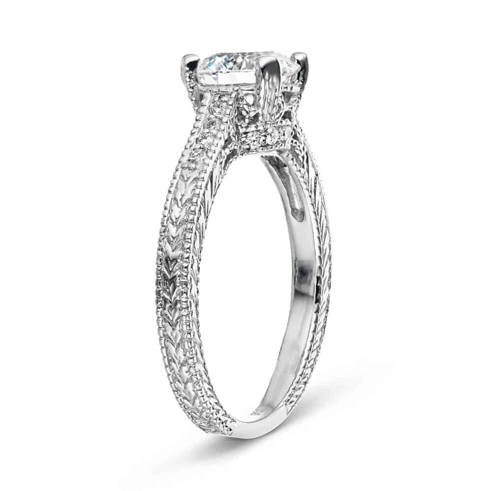 Shown with 1ct Round Cut Lab Grown Diamond in 14k White Gold|Antique style diamond accented engagement ring with 1ct round cut lab grown diamond in 14k white gold filigree detailed band shown from side