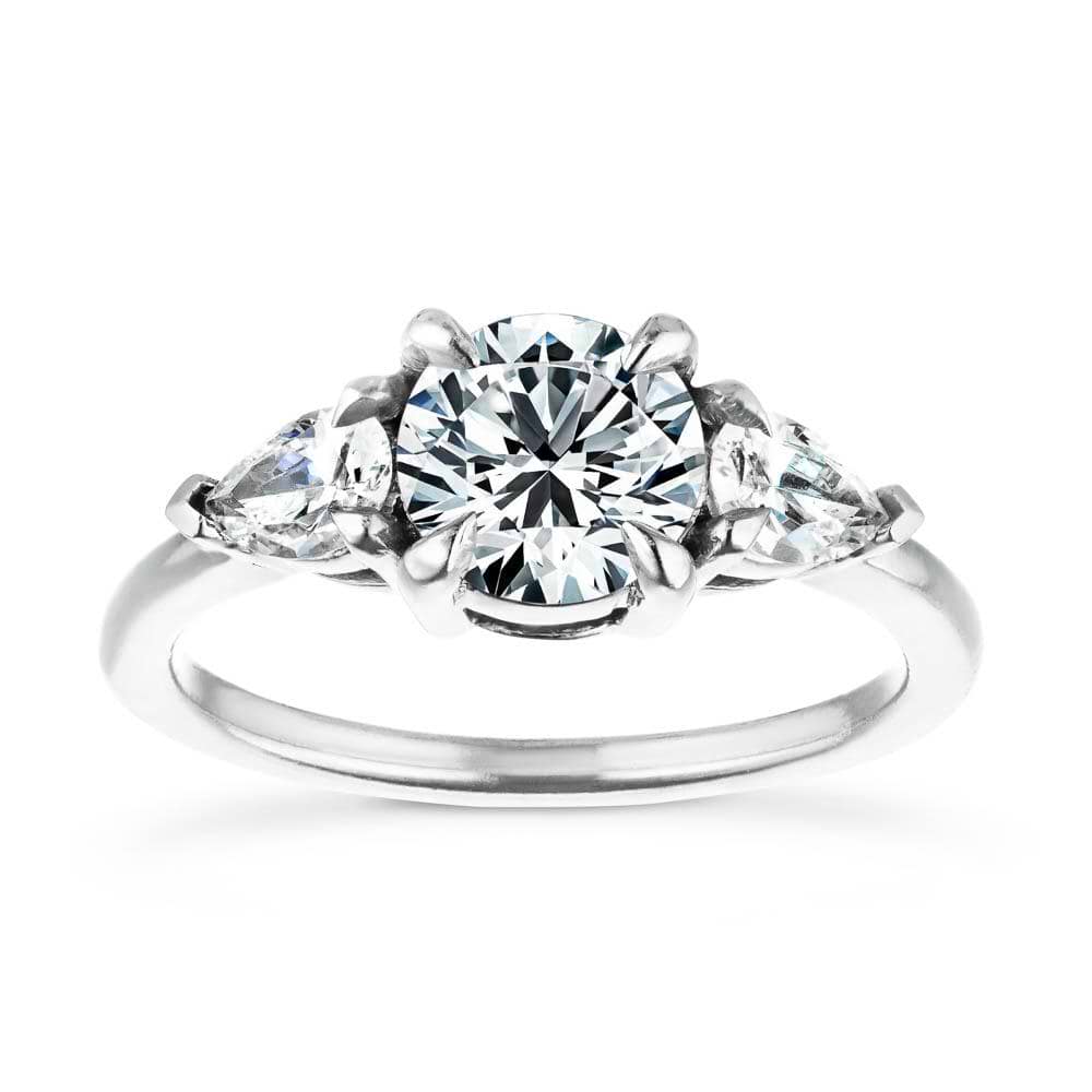 Shown with 1ct Round Cut Lab Grown Diamond Center Stone in 14k White Gold|Ethical three stone engagement ring with 1ct round cut lab grown diamond center and 0.5ct pear cut diamond side stones in 14k white gold